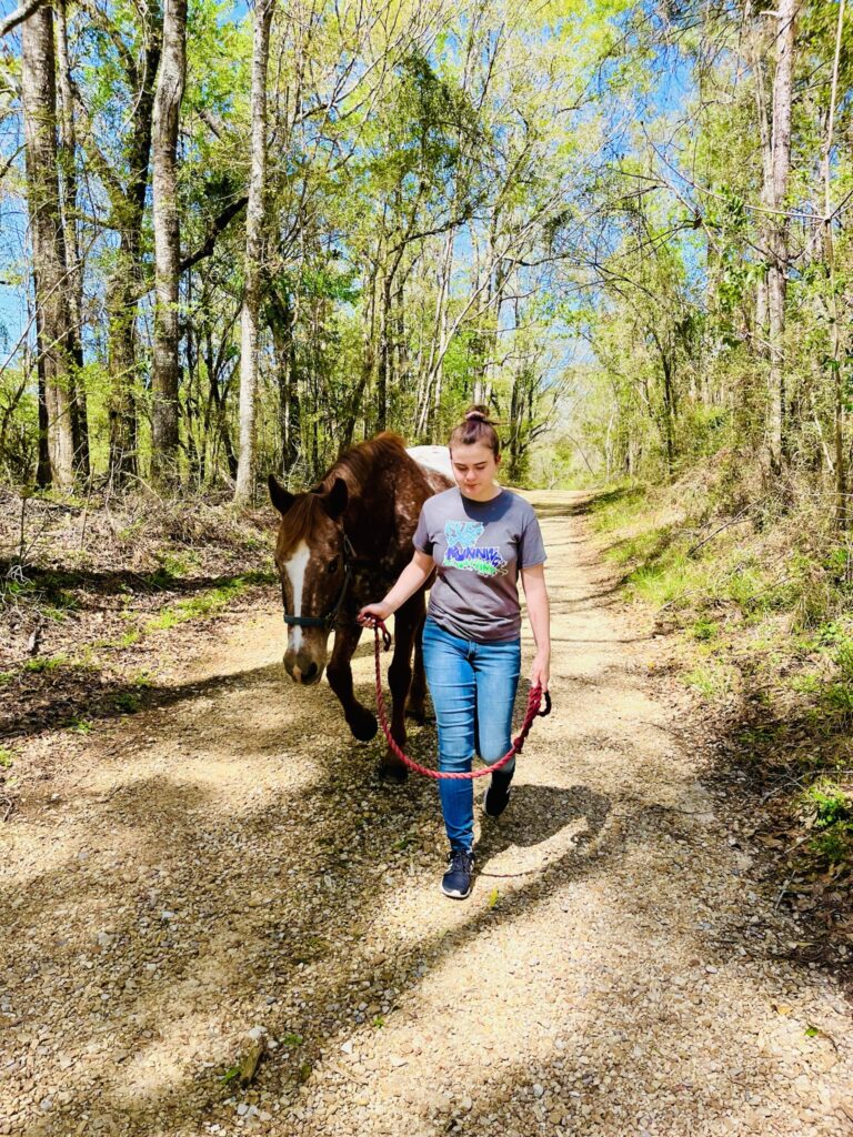 Women experience equine therapy services on walking on trail at our farm